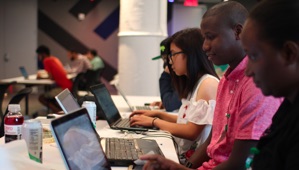 Photo of students working on laptops